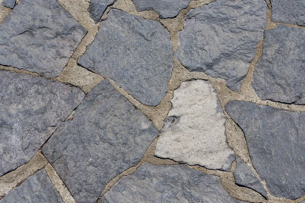 Duvarın veya pistin taş dokusu.
