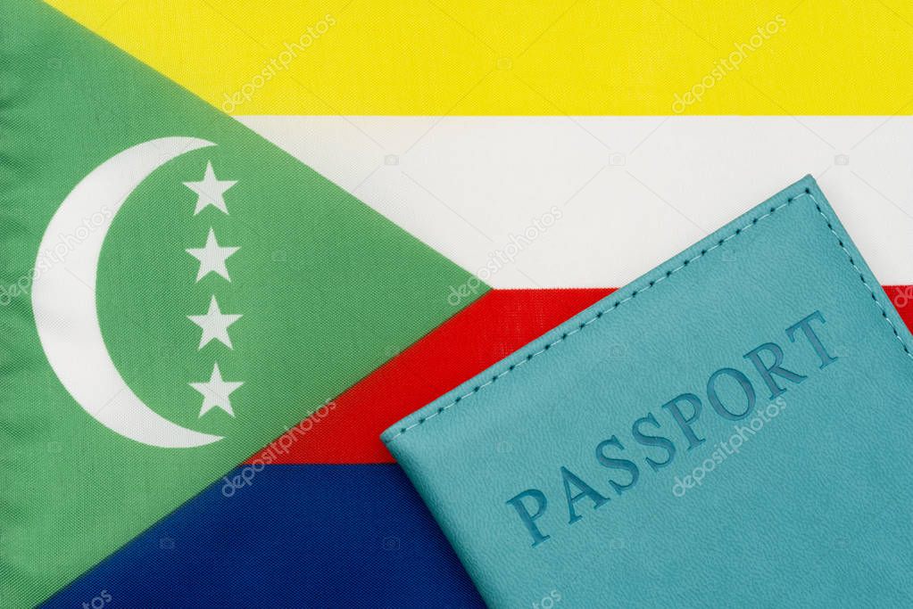 Against the background of the flag of Comoros is a passport.