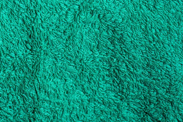Green, dry Terry towel as a background for the sauna. Green towel for wiping the body.