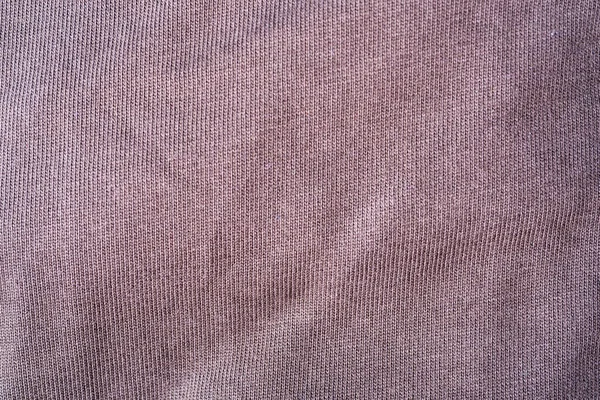 Texture of brown, cotton fabric, crumpled fabric. Clean and dry brown cloth.