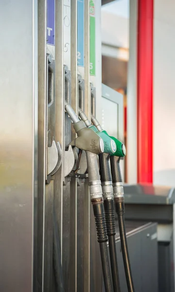 gas guns inserted in gas station at gas station during the day