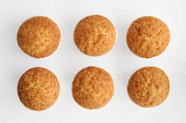 Kekler beyaz arka planda, iki sıra halinde, izole edilmiş, yukarıdan çekilmiş..