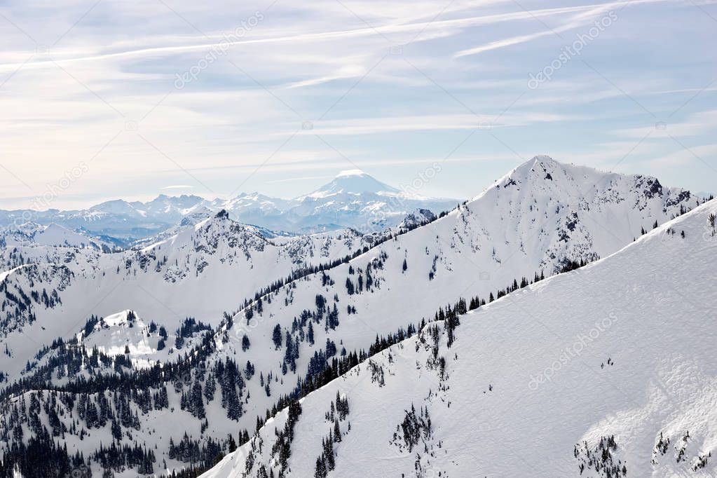 Cascade Mountains in Washington State are cover in snow during the winter season. Mt Adams can be seen in the center background.