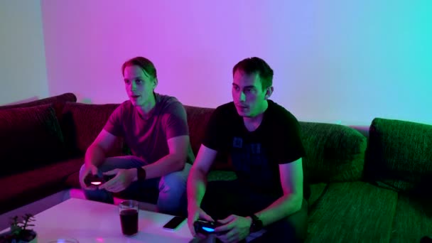 Two Happy Friends Playing Action Video Game Living Room Sitting — Wideo stockowe