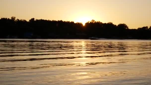Искрящаяся Река Лучах Заходящего Солнца Волны Воде Проходящей Лодки Оранжево — стоковое видео