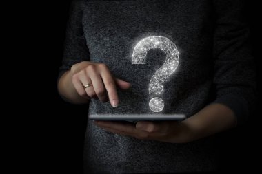 Elin parmağı tablete baskı yapıyor ve üzerinde soru işareti olan bir hologram var.