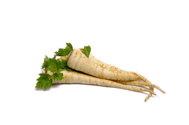 Beyaz arka planda yeşil yapraklı maydanoz kökü