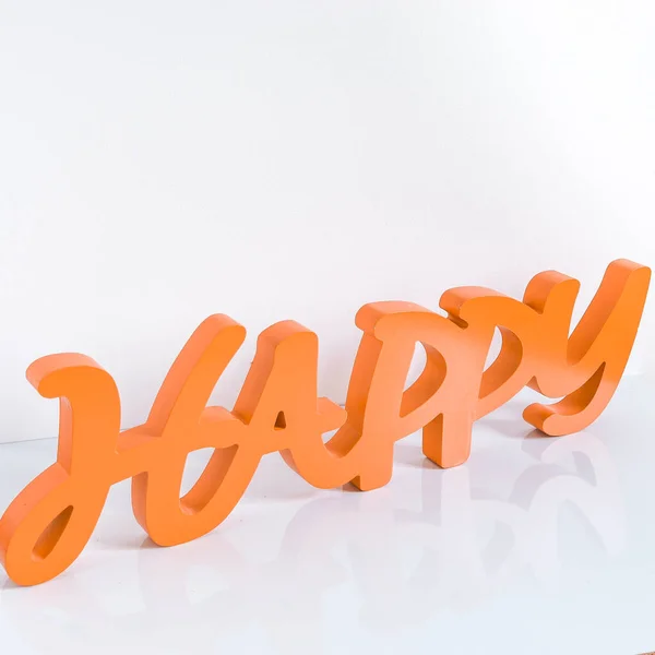 Word happy in orange on white background