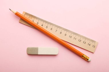 Cetvel Kalem ve silgi bir pastel pembe yalan. Üstten görünüm