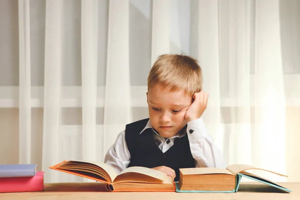 Schoolboy Sits Table Reads Lot Books Concept School — Stock Photo, Image