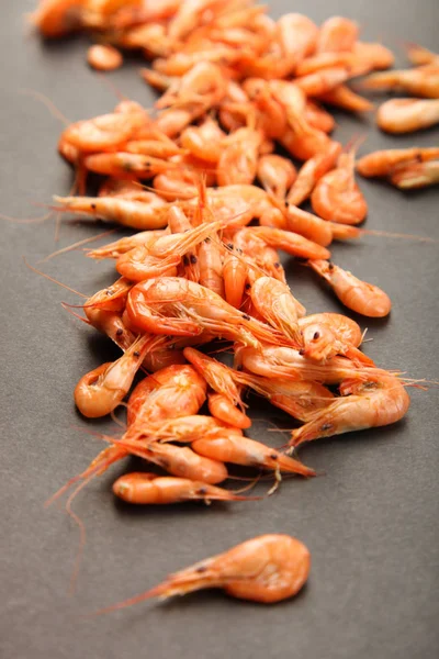 Boiled shrimp on black background. Concept seafood.