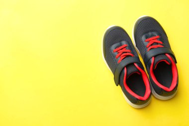 Sarı zemin üzerine siyah spor ayakkabı. Konsept spor.