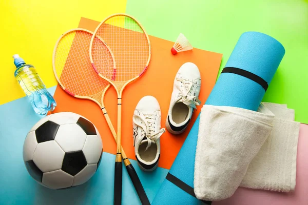Different sports equipment on bright multi-colored background.