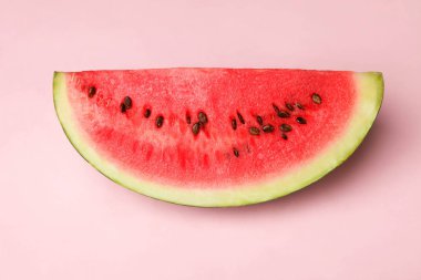 Pembe bir arka plan üzerinde kırmızı karpuz dilim. Üstten görünüm.