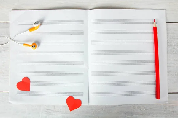 Notebook for musical notes and headphones. Concept music.