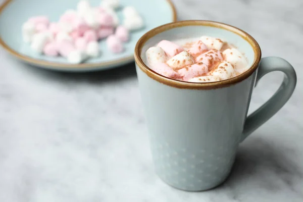 stock image Cup of coffee with marshmallows on marble background.