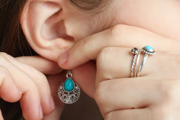 Girl Puts Earring Turquoise Stone Her Ear Rings Her Finger — Stock Photo, Image