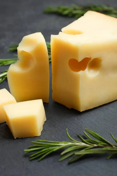 Hard Sliced Yellow Maasdam Cheese Rosemary Slate Board Black Background — Stock Photo, Image
