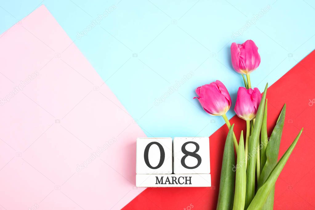 Beautiful pink tulips and calendar on bright colored background. Concept International Women's Day, March 8. Top view.