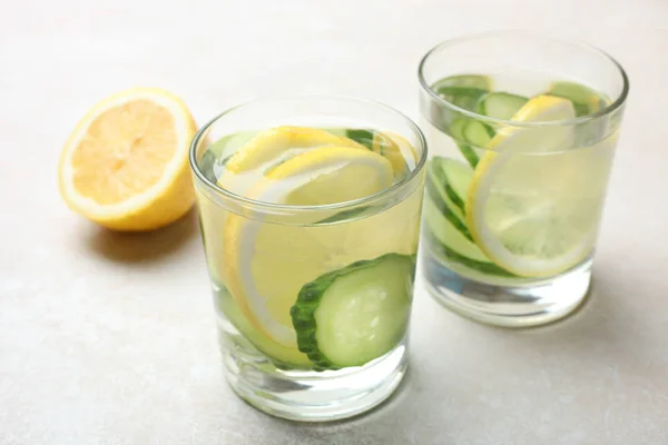 cup of  water with lemon and cucumber