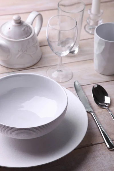 Λευκά πιάτα, μαχαιροπίρουνα, βραστήρας και ποτήρια — Φωτογραφία Αρχείου