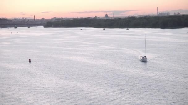 Transprt, reservoirs, travel, navigation concept - aerial survey from height bridge ower pond with boats ships yachts and other tourist water vessels on wide river Dnipro in Kiev at sunset. — Stock Video