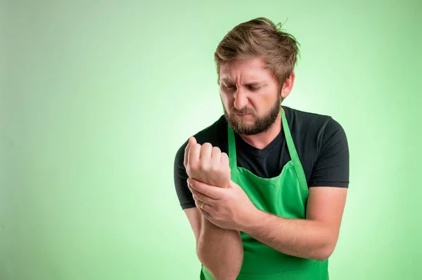 Supermarket Employee Green Apron Black Shirt Has Wrist Pain Isolated — Stock Photo, Image