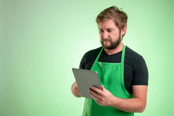 Supermercato Dipendente Con Grembiule Verde Shirt Nera Prende Appunti Guardando — Foto Stock