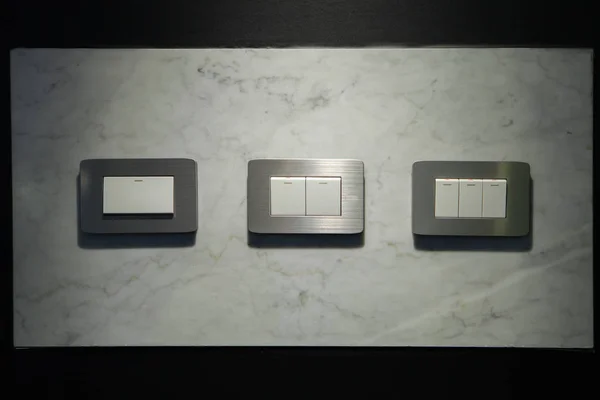 Modern light electrical switch with modern marble background.