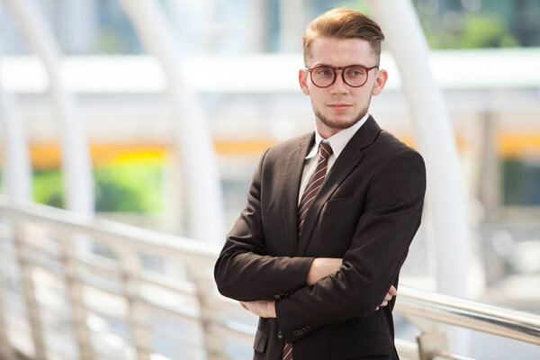 Confident businessman. Confident young man in full suit looking away while standing outdoors