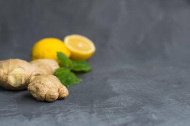 Limon ve naneli zencefil kökü ya da gri arka planda mellis yaprakları. düz alan, kopyala boşluk