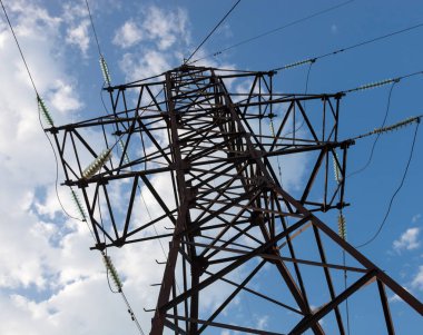 Bulutlu gökyüzü arka planına karşı elektrik direği.