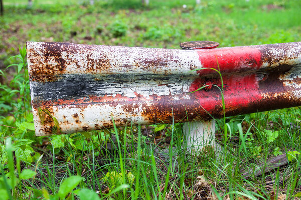 Old metal traffic barrier in the grass