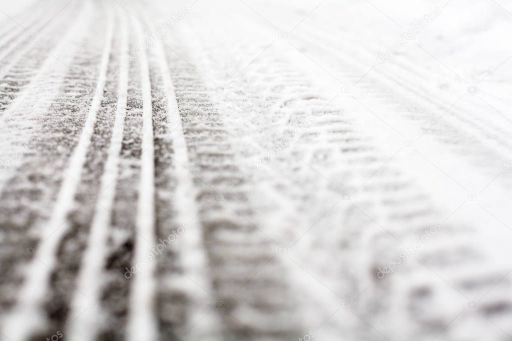 Wheel tracks on the winter road covered with snow.