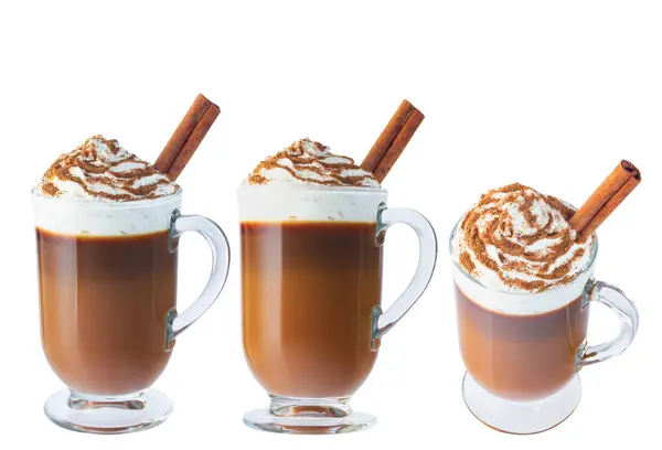 Coffee, cappuccino with whipped cream in a glass, Irish glass. Ground cinnamon, cinnamon stick. Isolate on a white background. The photo.