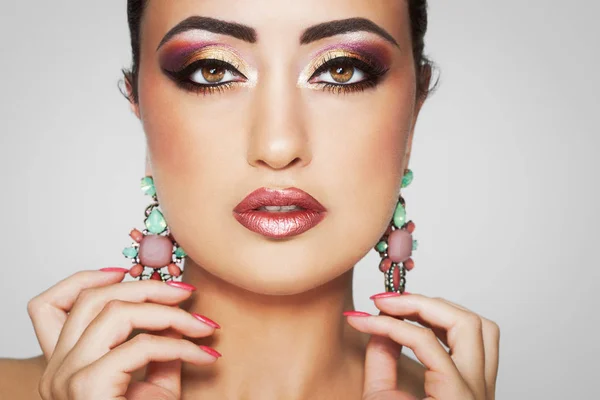 Beautiful exotic woman with exquisite Arabic glitter based makeup.