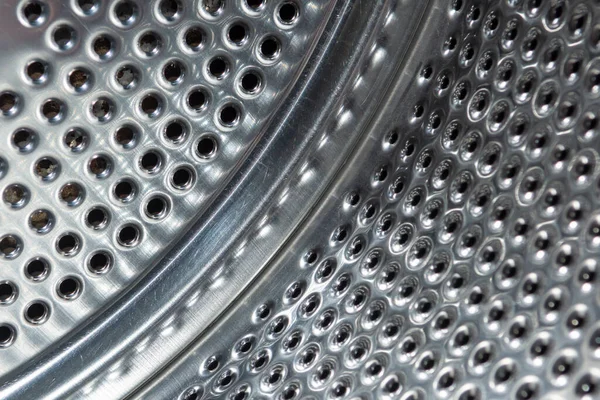 stainless steel metal surface with many round holes
