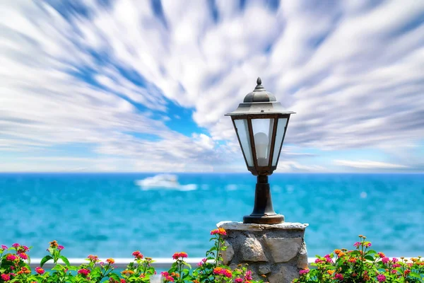 Summer sea panorama from Cyprus restaurant with flowers and blue cloudy sky