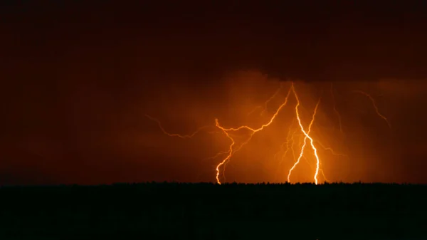 Several lightning strikes during a strong thunderstorm over the lake — Stock Photo, Image