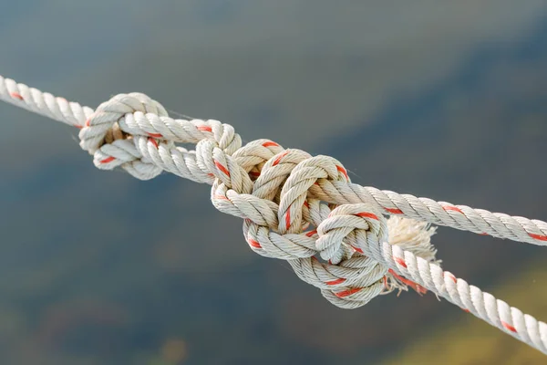 Old fishing boat rope with a Tied Knot on gray background — Stock Photo, Image