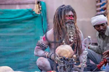 Varanasi, Uttar Pradesh, Hindistan - 21 Mart 2024: Masan Holi, Harishchandra ghat 'ta düzenlenen the Varanasi Holi festivali sırasında kimliği belirsiz bir erkek ağustos sadhu portresi.