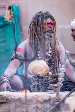 Varanasi, Uttar Pradesh, Hindistan - 21 Mart 2024: Masan Holi, Harishchandra ghat 'ta düzenlenen the Varanasi Holi festivali sırasında kimliği belirsiz bir erkek ağustos sadhu portresi.