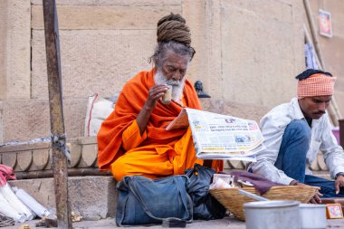 Varanasi, Uttar Pradesh, India - March 21, 2024: Portrait of an unidentified young snake charmer male at ghat near ganga river in varanasi city.