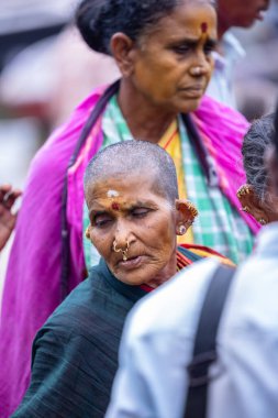 Varanasi, Uttar Pradesh, India - March 21 2024: Portrait of an unidentified holy brahmin in traditional dress at the ghats near ganges in varanasi during winter morning.