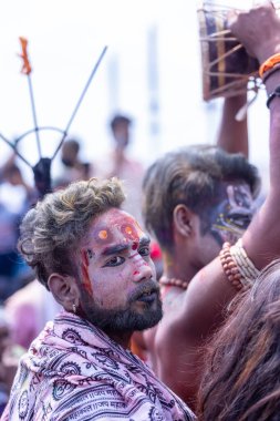 Varanasi, Uttar Pradesh, India - March 21, 2024: Masan Holi, Masan Holi, Group of unidentified devotees participating in masan holi festival at manikarnika ghat of varanasi with colours.