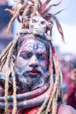 Varanasi, Uttar Pradesh, India - March 20, 2024: Masan Holi, Portrait of an male devotee with painted face with dry ash dressed as lord shiva during the celebration of masan holi at harishchandra ghat.