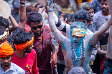Varanasi, Uttar Pradesh, India - March 21, 2024: Masan Holi, Masan Holi, Group of unidentified devotees participating in masan holi festival at manikarnika ghat of varanasi with colours.