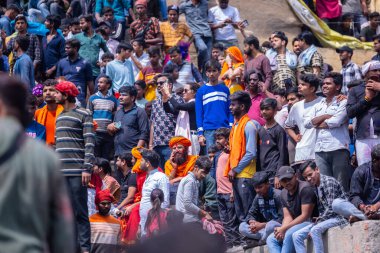 Varanasi, Uttar Pradesh, India - March 21, 2024: Masan Holi, Masan Holi, Group of unidentified devotees participating in masan holi festival at manikarnika ghat of varanasi with colours.