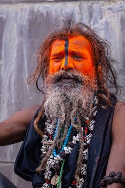 Varanasi, Uttar Pradesh, India - March 20, 2024: Masan Holi, Portrait of an male devotee with painted face with dry ash dressed as lord shiva during the celebration of masan holi at harishchandra ghat.