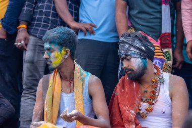 Varanasi, Uttar Pradesh, India - March 21, 2024: Masan Holi, Masan Holi, Group of unidentified devotees participating in masan holi festival at manikarnika ghat of varanasi with colours.